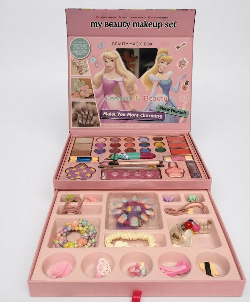 A children's beauty makeup set in a pink box, shown open to reveal an eyeshadow palette, brushes, nail polish, and various small cosmetic accessories arranged in compartments. The box lid features cartoon princess illustrations and the text 'my beauty makeup set'.