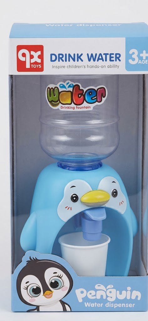 A 9X Toys Penguin Water Dispenser in its original retail packaging. The dispenser is light blue with a penguin face, featuring a clear water bottle on top and a white cup under a blue spout.