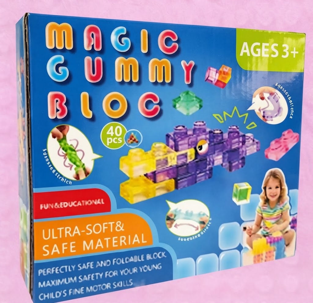 Magic Gummy Bloc toy building block set in its blue retail box, featuring colorful lettering, product illustrations, and age 3+ text on a pink background.