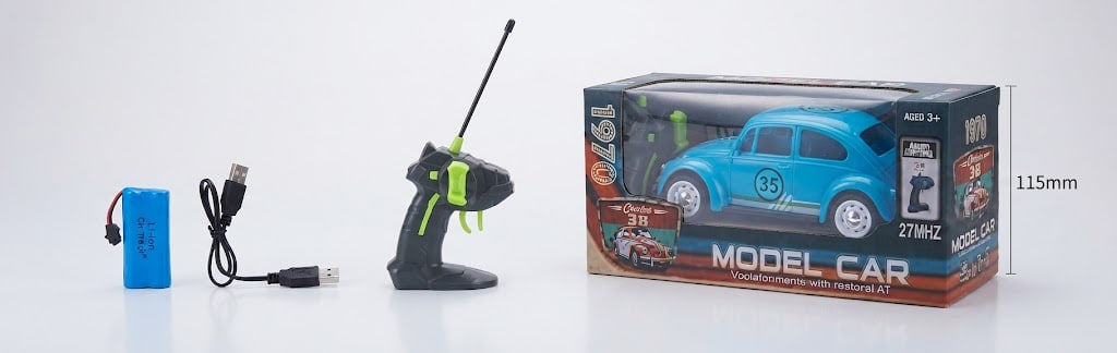 A remote control model car set shown with its packaging box, a black and green handheld controller, a blue battery, and a USB charging cable on a white background. The box features a blue Volkswagen Beetle design and includes a dimension marker of 115mm.