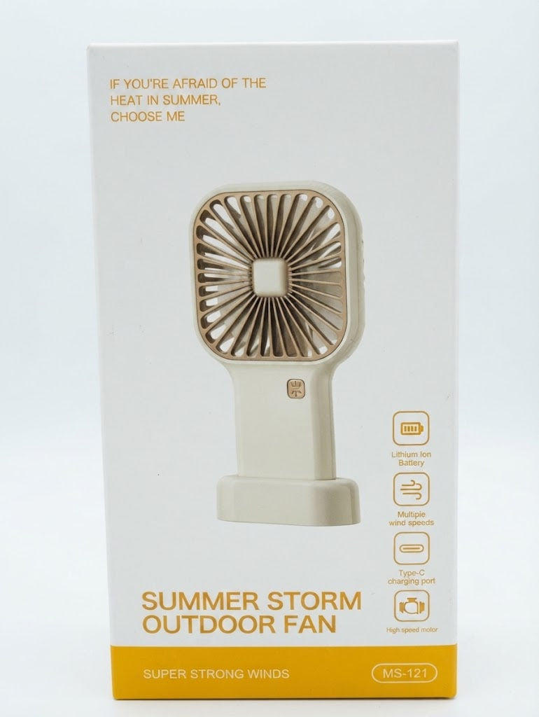 White product packaging box for a portable handheld fan, featuring a printed illustration of the cream-colored fan with gold accents and orange text reading 'SUMMER STORM OUTDOOR FAN'.
