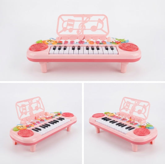 Pink plastic toy electronic keyboard with black and white keys, decorative musical note graphics on the arch, colorful buttons, and round red side controls, shown from three angles on a white background. best 24 key electronic piano keyboard toy for kids, buy interactive musical piano toy online pakistan, kids 24 key piano with music functions gift