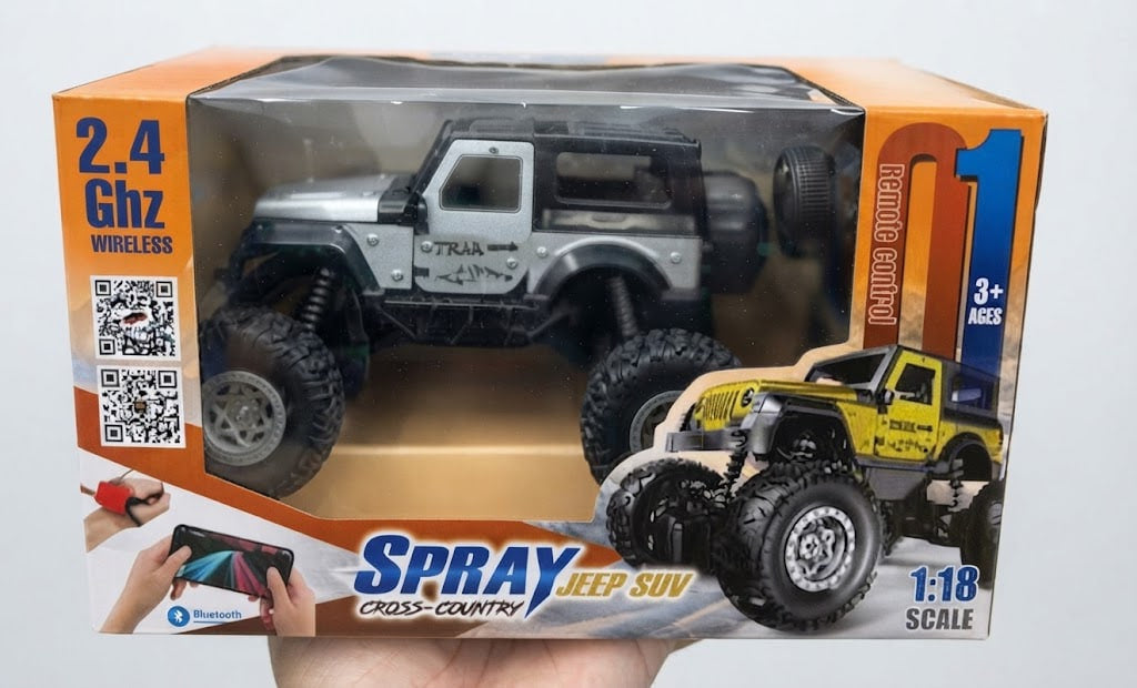 A boxed wireless remote-controlled cross-country jeep SUV toy, shown in its retail packaging with a hand holding the bottom. The box features a silver and black jeep pictured through the clear window, plus printed graphics of the remote control and a yellow monster truck.