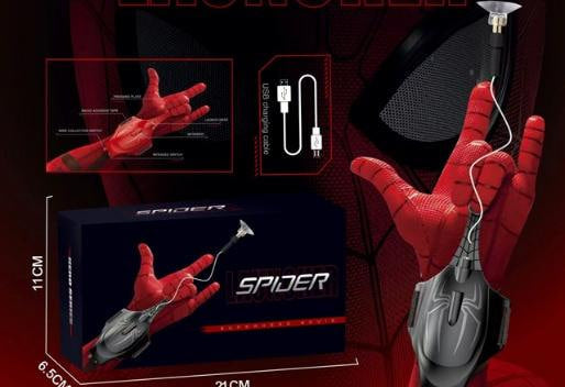 Spider-themed wireless computer mouse and headset set shown with its retail box, a charging cable, and a hand wearing the red Spider wristband. The image includes dimension labels on the box and a close-up inset of the handband on a dark red Spider costume background.