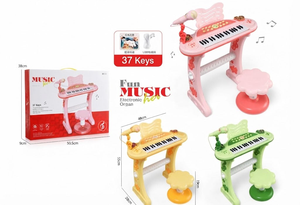 A children's toy music desk set shown with its retail box, plus three color variants of the toy piano and pedal: pink, yellow, and green. The main featured product on the right is pink with black and white keys, a matching pink pedal, and a small microphone accessory.