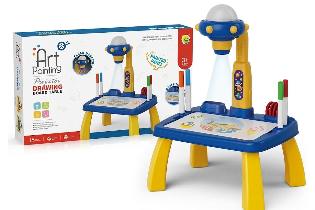 A children's projector drawing board table set shown with its retail box. The toy features a blue and yellow table with a white drawing surface, a blue-and-yellow projector lamp, several colored markers, and a projector beam graphic indicating the projection feature.