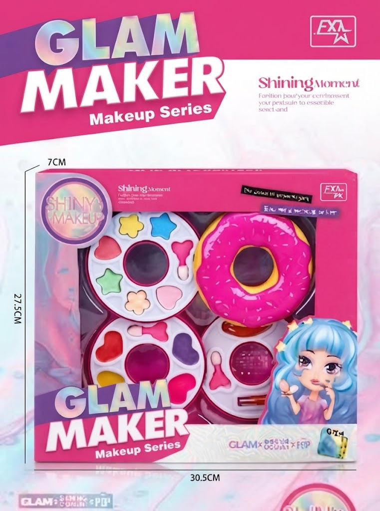 Glam Maker Makeup Series toy set in its retail packaging, featuring a pink donut-shaped makeup sponge, round makeup sponges with colorful star, heart, and flower patterns, and a blue-haired doll character illustration on the box.